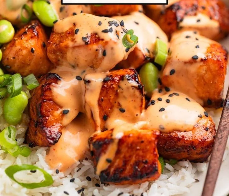 Air fryer salmon bites served with Bang Bang Sauce on a plate.