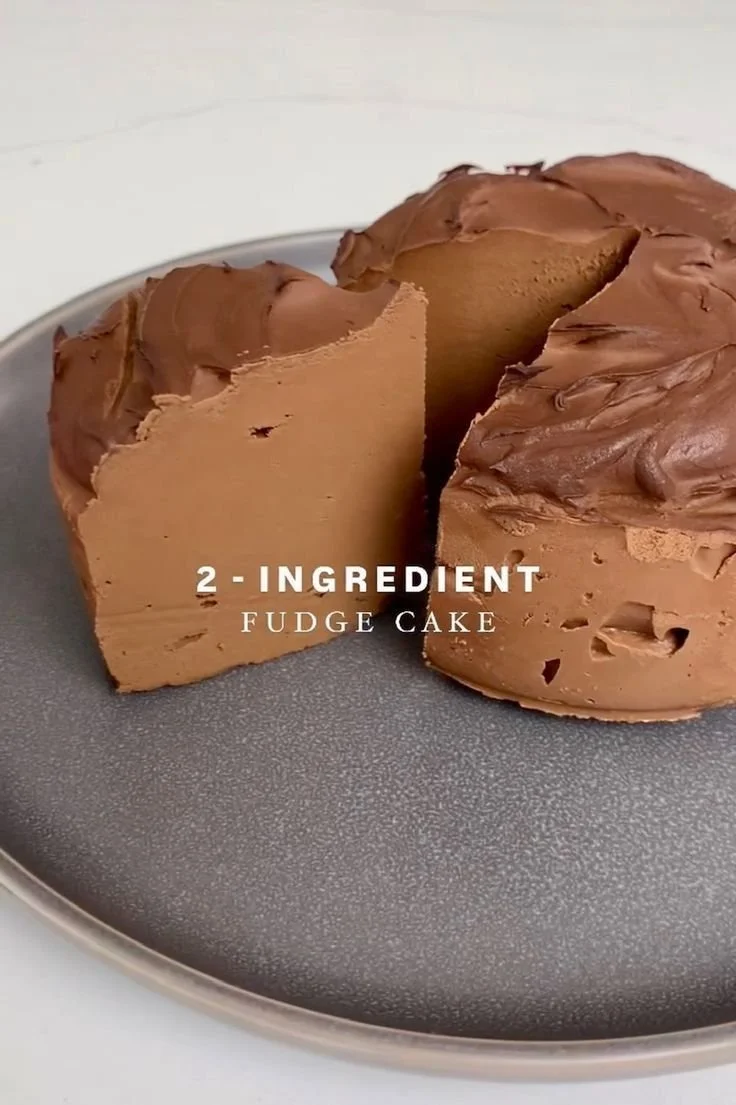 Delicious 2-ingredient fudge cake drizzled with chocolate.