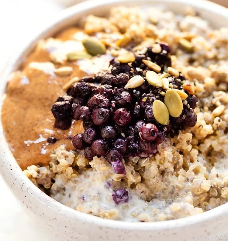 Bowl of chai spiced quinoa topped with fruits, ready for breakfast