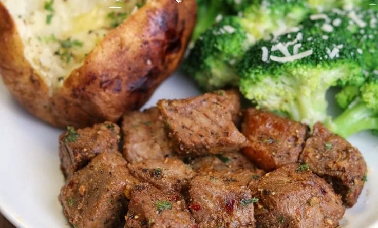 Juicy air fryer steak bites served on a plate with seasoning