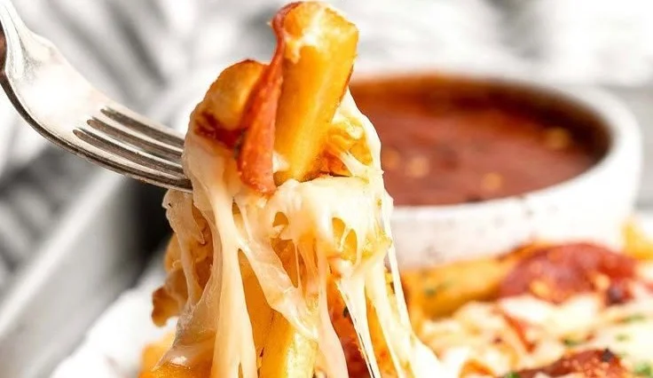 Delicious baked pizza fries topped with cheese and pepperoni