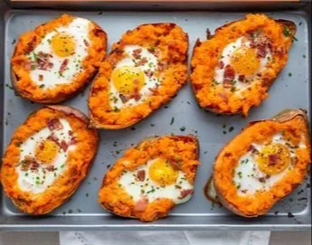 Breakfast sweet potato recipe topped with eggs and greens
