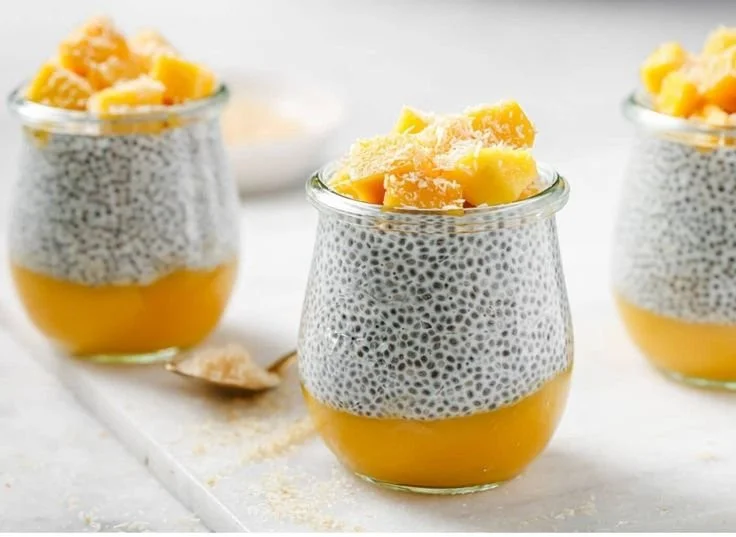 Chia seed pudding topped with coconut milk and mango slices