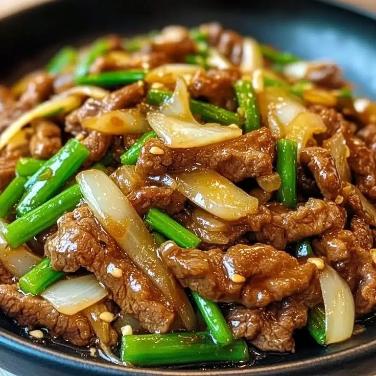 Chinese beef stir fry with onions in a colorful vegetable medley