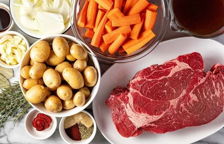 Delicious crock pot pot roast with vegetables and gravy served on a plate