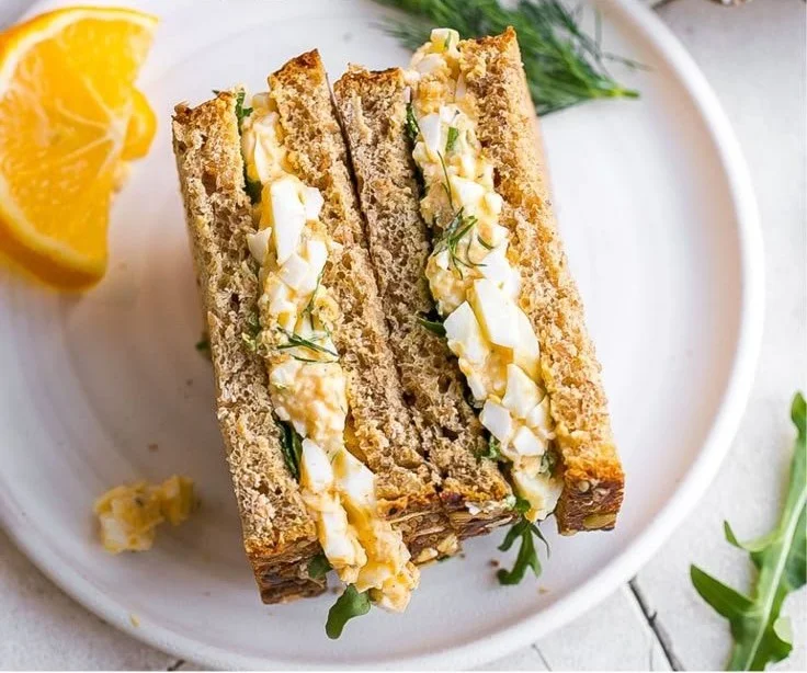 Delicious egg salad with dill in a bowl, perfect for sandwiches or snacks.
