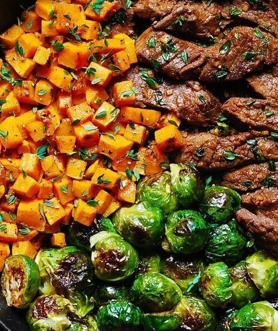 Delicious Garlic Butter Steak served with roasted Brussels sprouts.