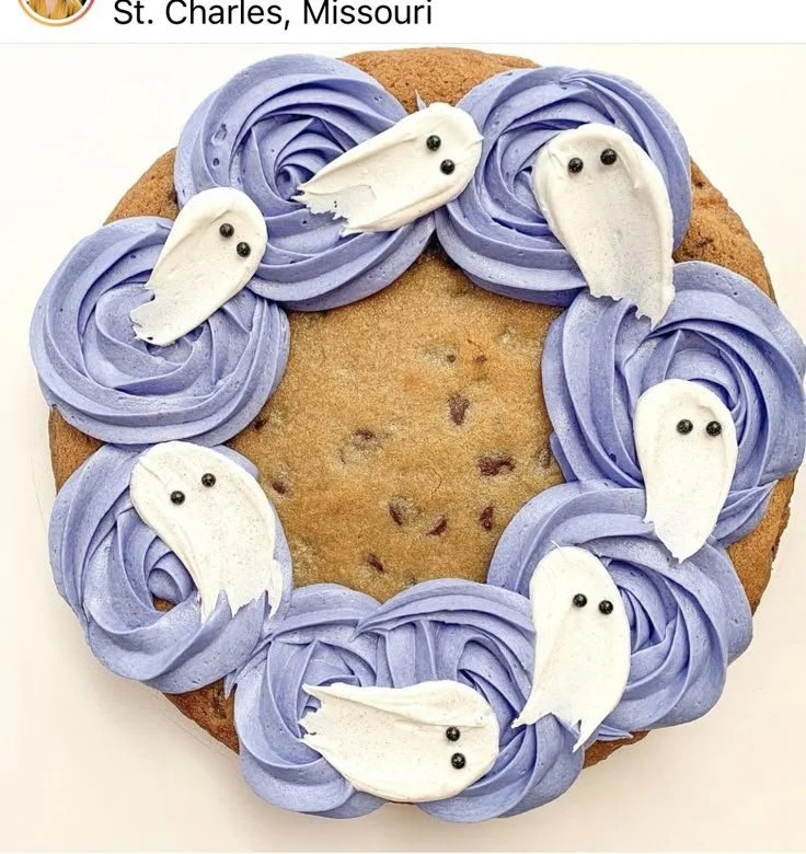 Spooky ghost Halloween cookie cake decorated with icing and Halloween treats.