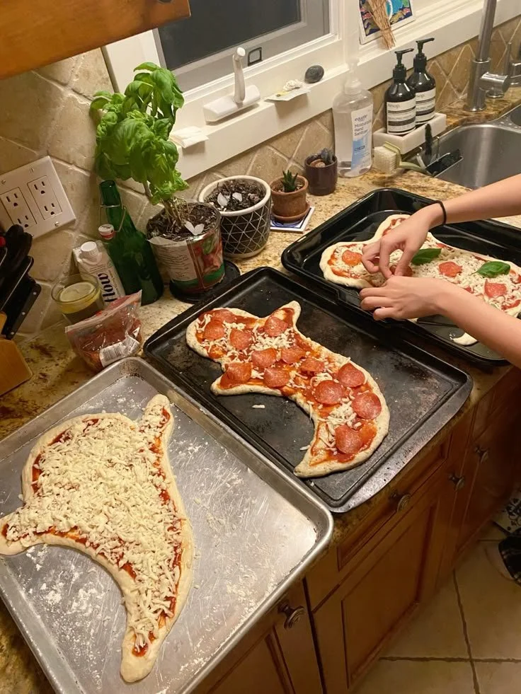 Spooky ghost pizza for a Halloween night gathering.