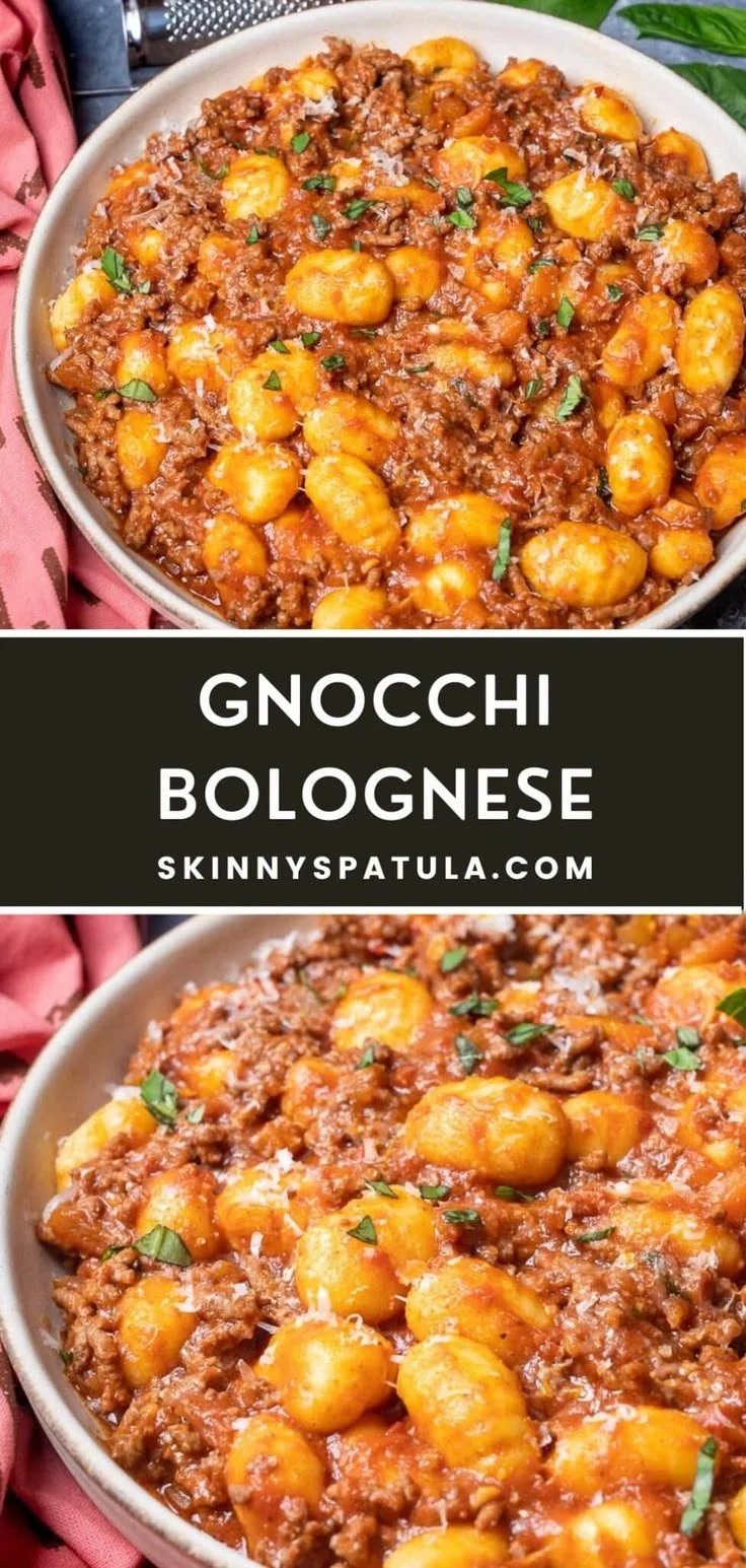 Bowl of delicious gnocchi bolognese topped with fresh herbs and cheese