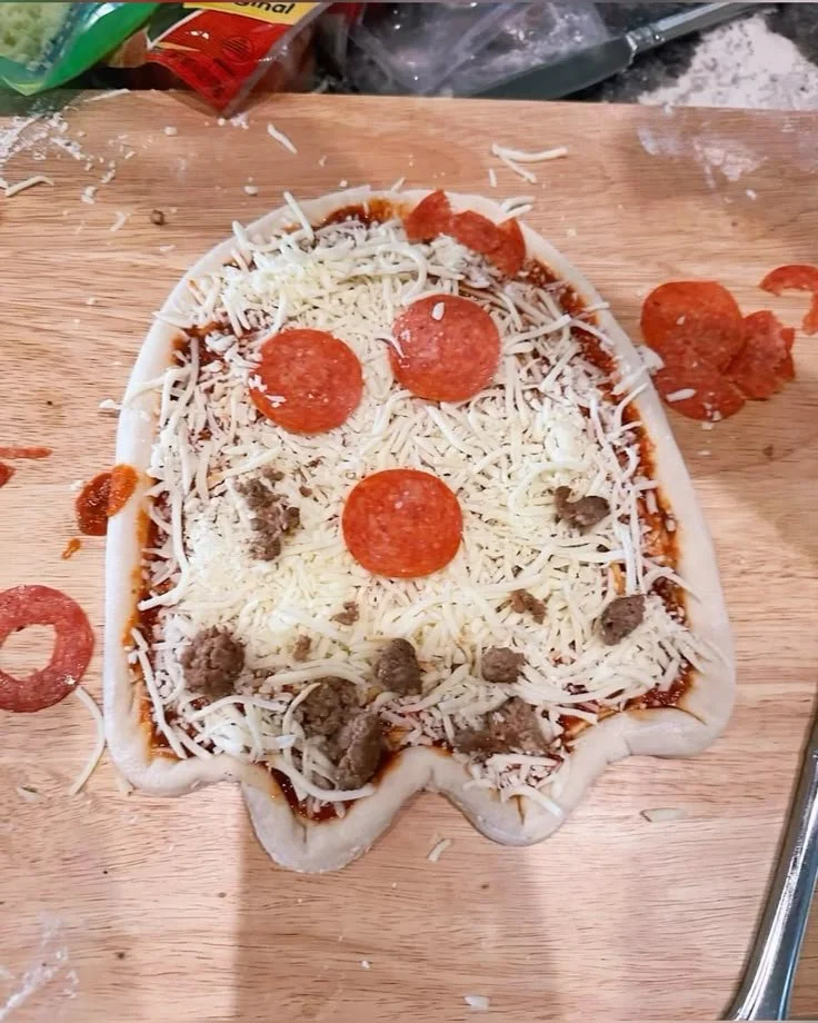 Halloween Ghost pizza topped with spooky designs for festive celebrations