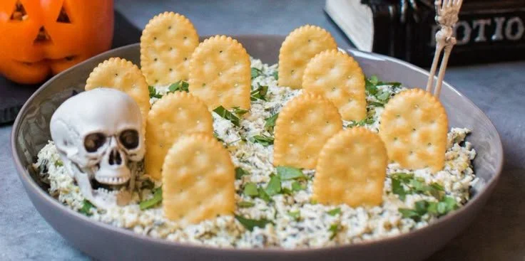 Spooky Halloween Graveyard Spinach Dip served in a festive dish