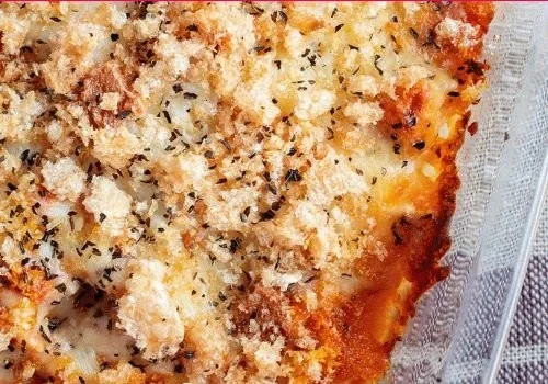 High protein chicken parmesan casserole dish garnished with herbs