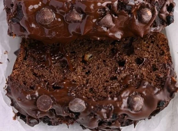 High-protein chocolate banana bread slice on a wooden table