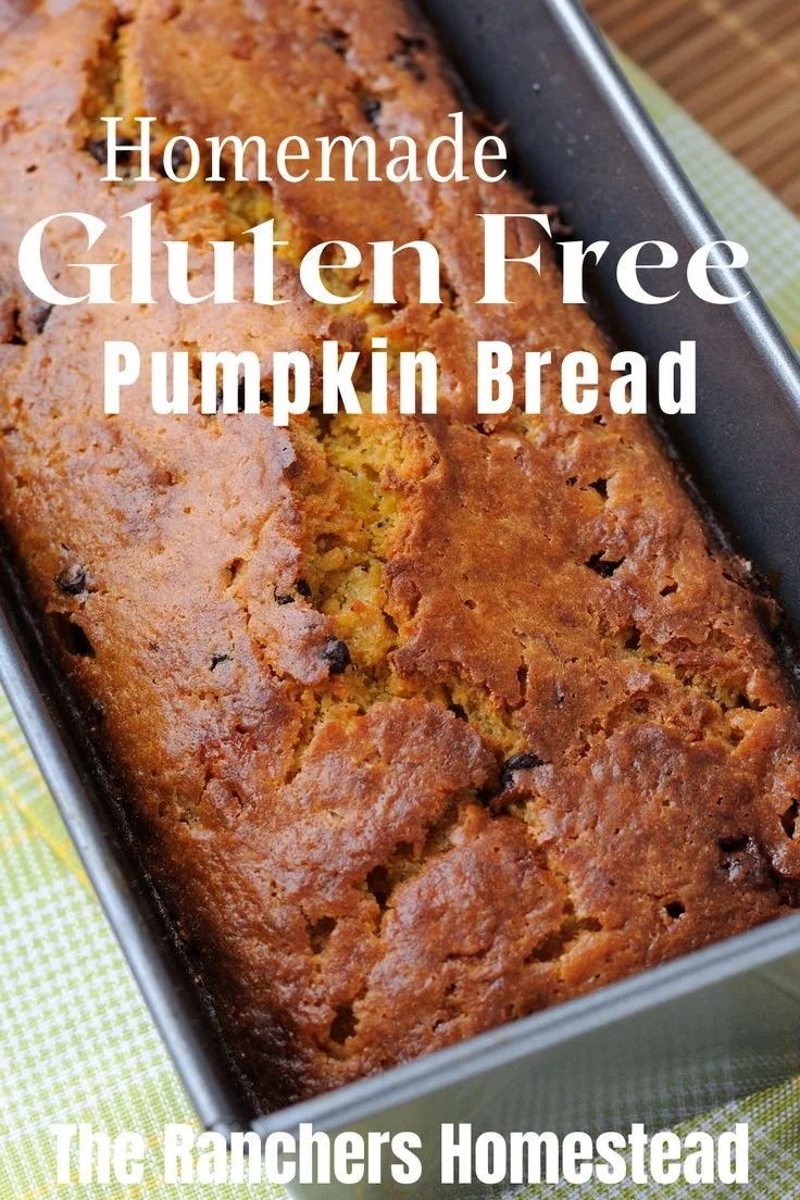 Homemade gluten free pumpkin bread served on a wooden table with fall decorations.