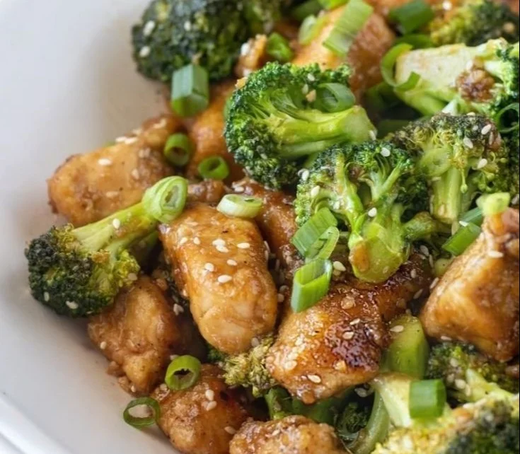 Delicious honey sesame chicken with broccoli on a plate.