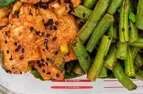 Honey Sriracha Chicken with Green Beans served on a plate