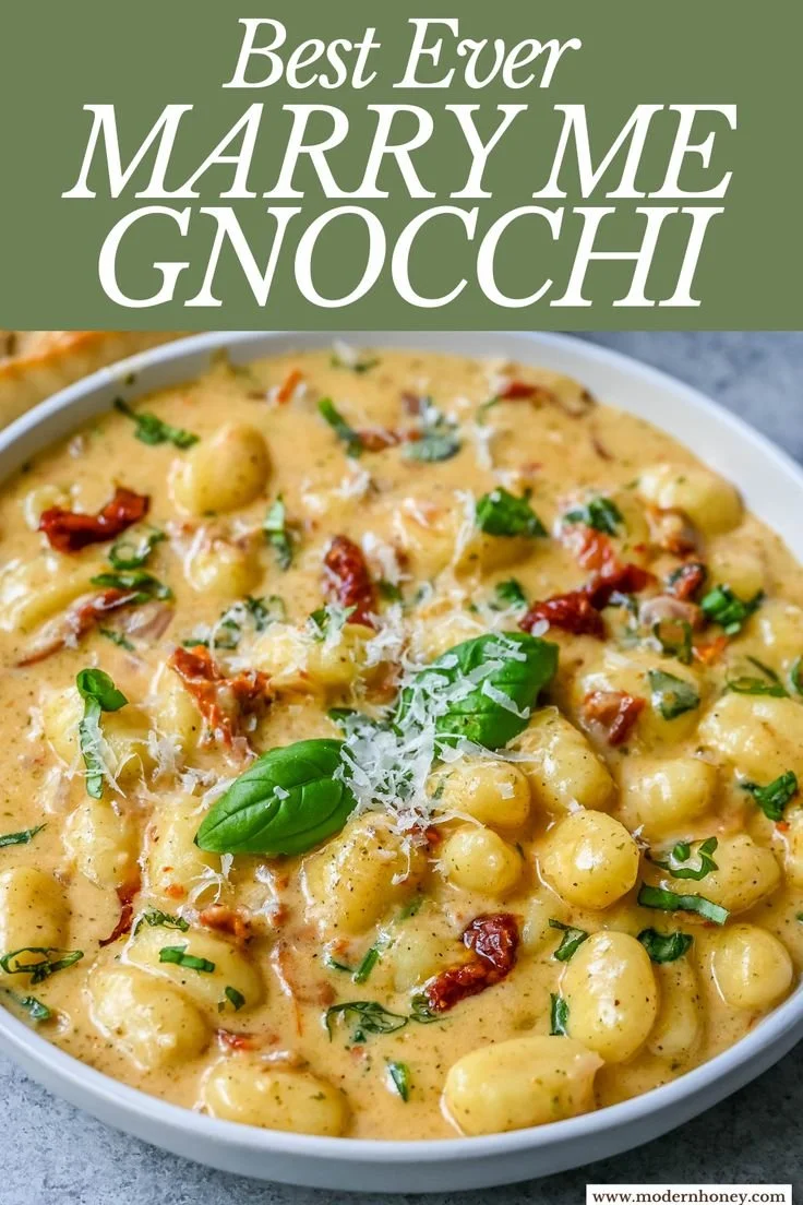 A plate of Marry Me Gnocchi topped with fresh herbs and sauce.