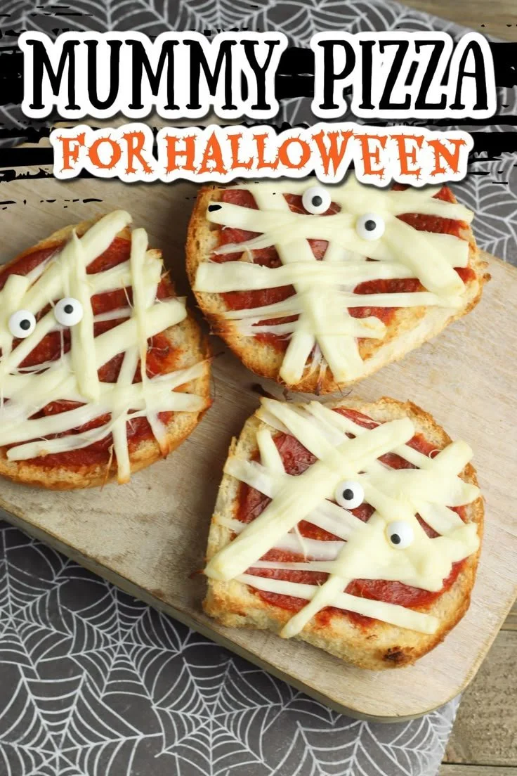 Delicious Mummy Pizza topped with cheese and olives for Halloween