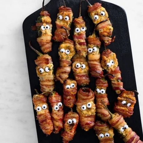 Halloween-themed jalapeño poppers filled with cheese and spices
