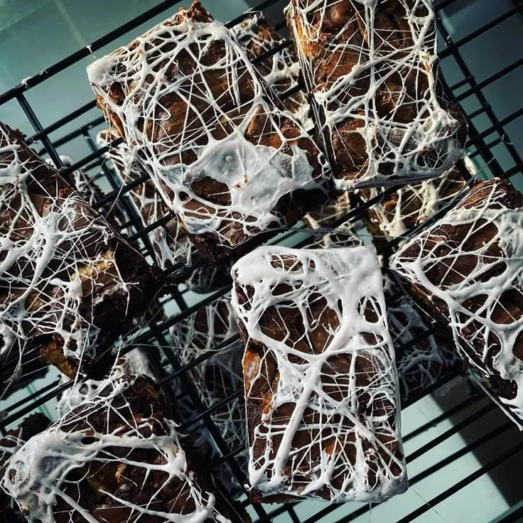 Spiderweb Brownies decorated with chocolate and white icing for Halloween