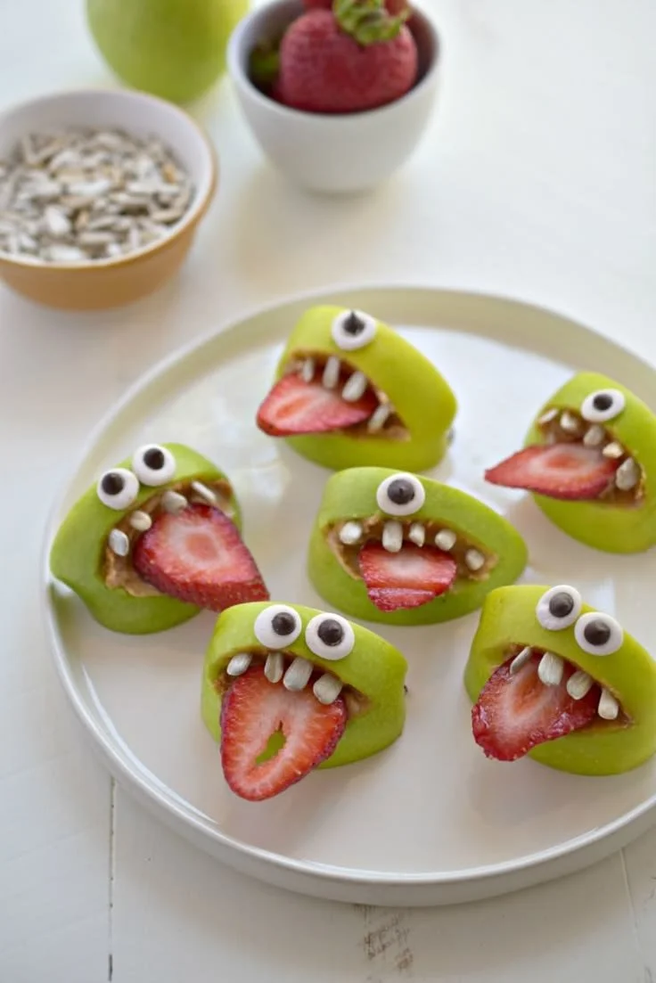 A variety of healthy Halloween snacks for kids displayed on a festive table.
