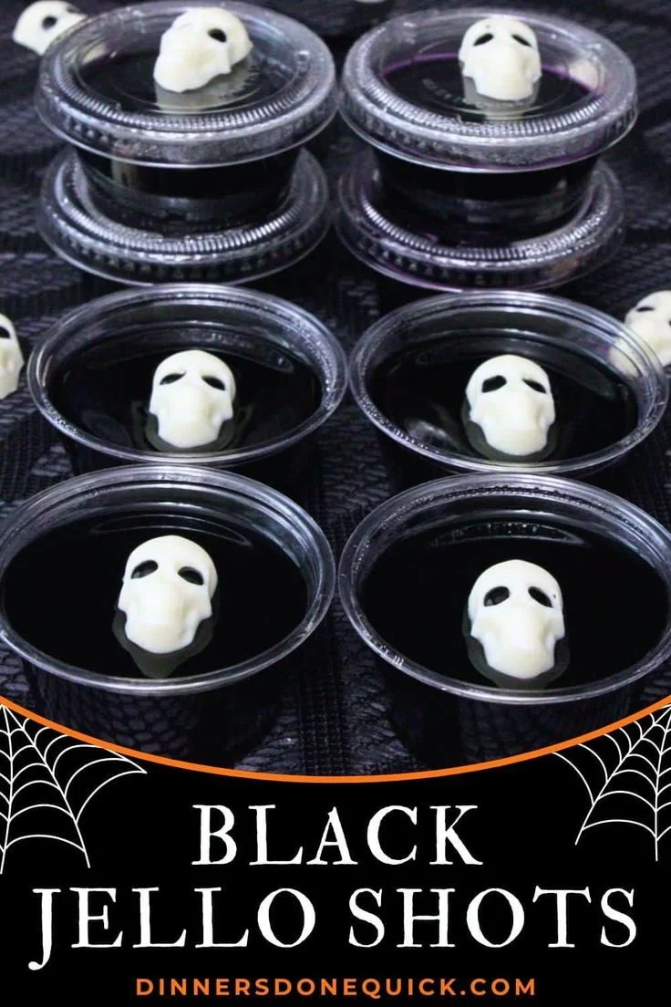 Spooky Black Jello Shots for Halloween parties, served in clear cups.