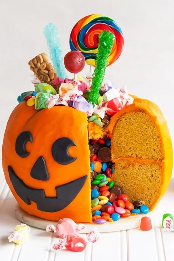 Candy-filled pumpkin pail cake decorated for Halloween festivities