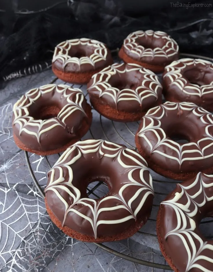 Chocolate Spiderweb Halloween baked donuts decorated for spooky festivities.