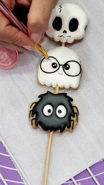 Cute Halloween cookies decorated with royal icing designs.