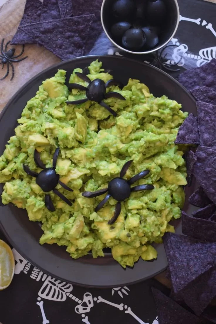 Creepy guacamole served in a spooky Halloween-themed bowl.