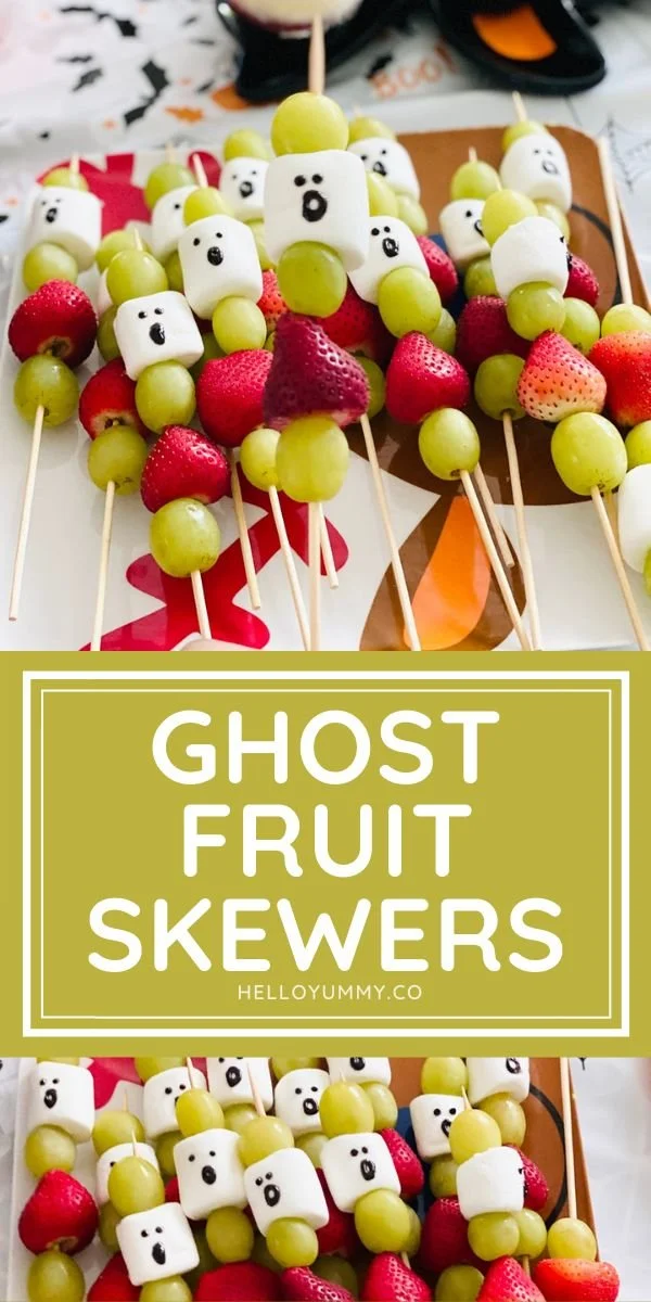 Halloween-themed Ghost Fruit Skewers with spooky faces made from fruit.