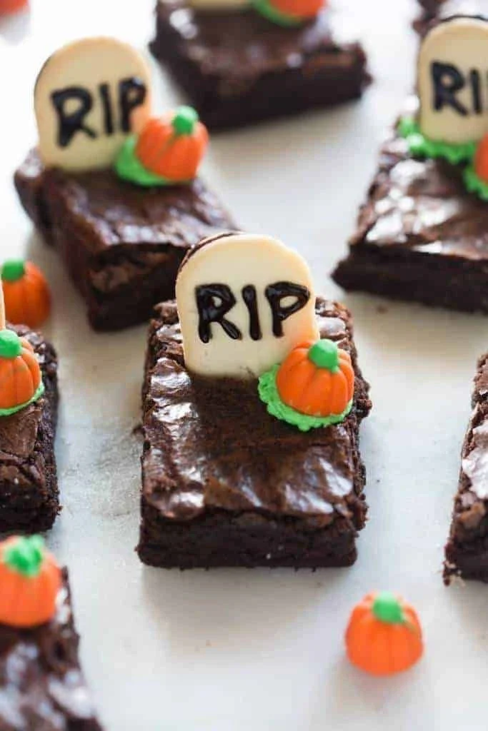 Spooky Graveyard Halloween Brownies decorated with edible ghosts and tombstones
