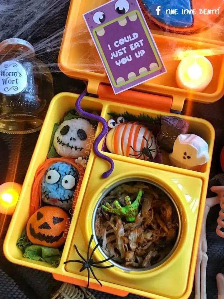 Colorful Halloween bento box filled with themed snacks and treats for kids.