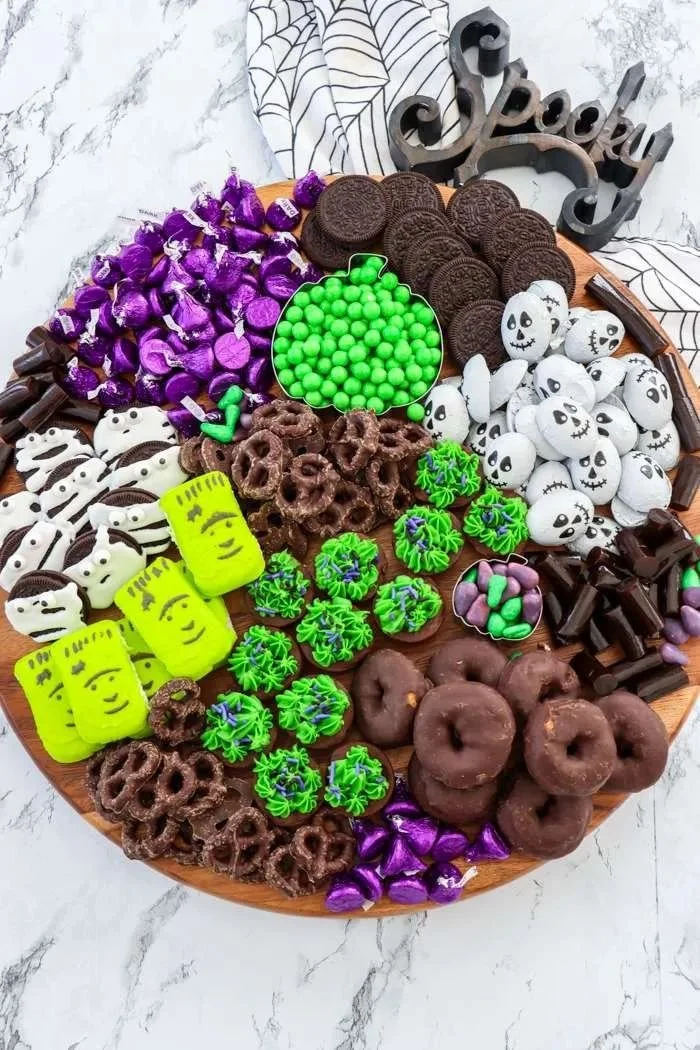 Halloween charcuterie board filled with spooky snacks and festive treats.