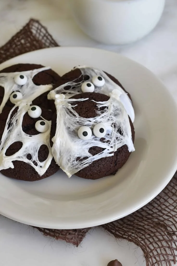 Halloween double chocolate spider web cookies decorated with white icing