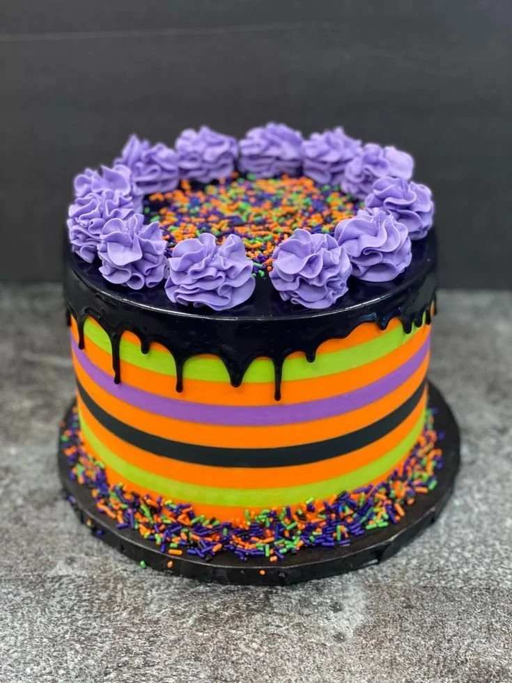 Colorful Halloween striped cake with layers of orange and black frosting