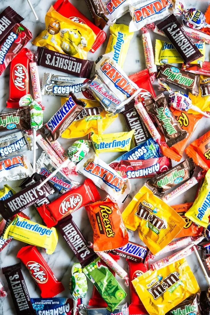 Assorted healthier candy options for Halloween filled with festive treats.