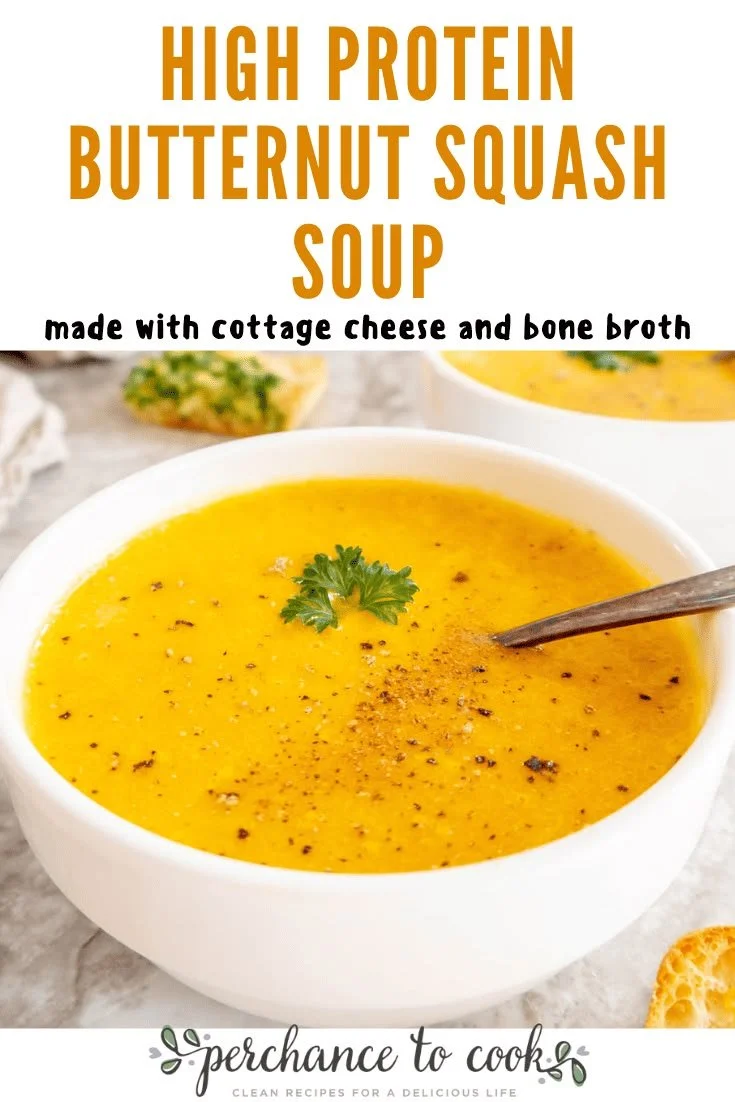 Bowl of high protein butternut squash soup garnished with herbs.