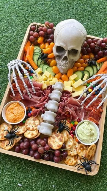 Festive Halloween platter with pumpkin treats and spooky snacks for a party.