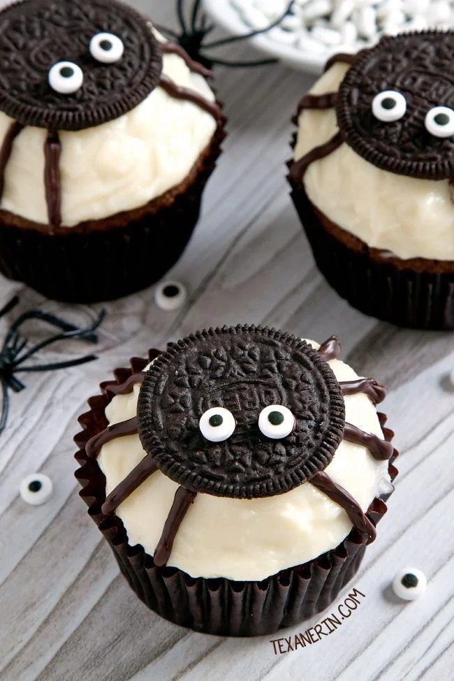 Spider Halloween cupcakes decorated with pumpkin cream cheese frosting