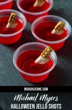 Strawberry jello shots with candy knives for Halloween festivities