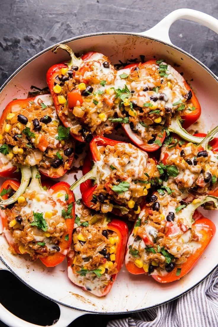 Colorful vegetarian stuffed peppers filled with grains and vegetables